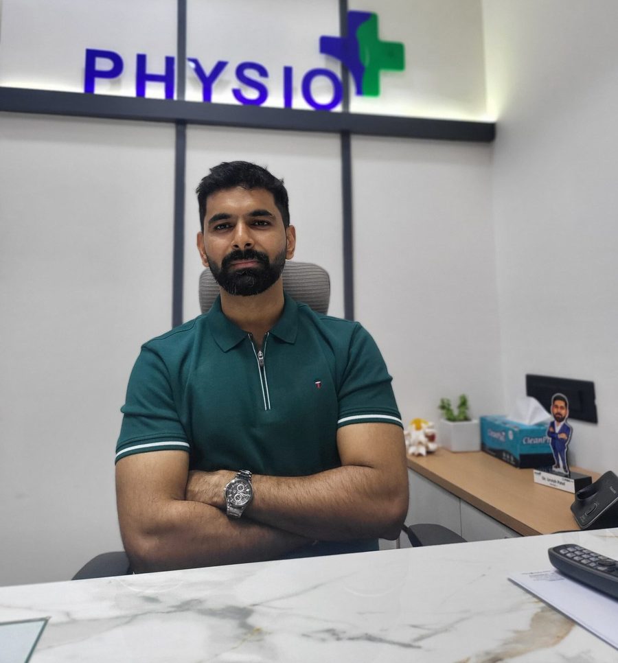 Dr. Urvish Patel at his desk at Physio+, Ahmedabad